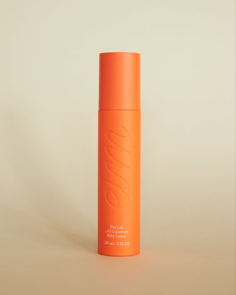 Elm bottle with embossed elm logo on a natural background